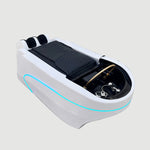 Load image into Gallery viewer, White massage bed with black cover on a gray floor, Shunlong logo visible