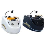 Two massage chairs, one white and one black with gold accents, on a marble floor.