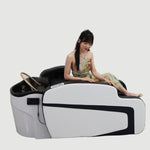 Load image into Gallery viewer, Woman sitting on a modern massage chair with Shunlong logo in the corner.
