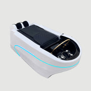 White massage bed with black cover on a gray floor, Shunlong logo visible