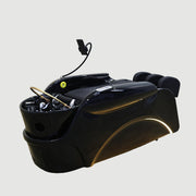 Black hair washing chair with Shunlong logo on a white wall background